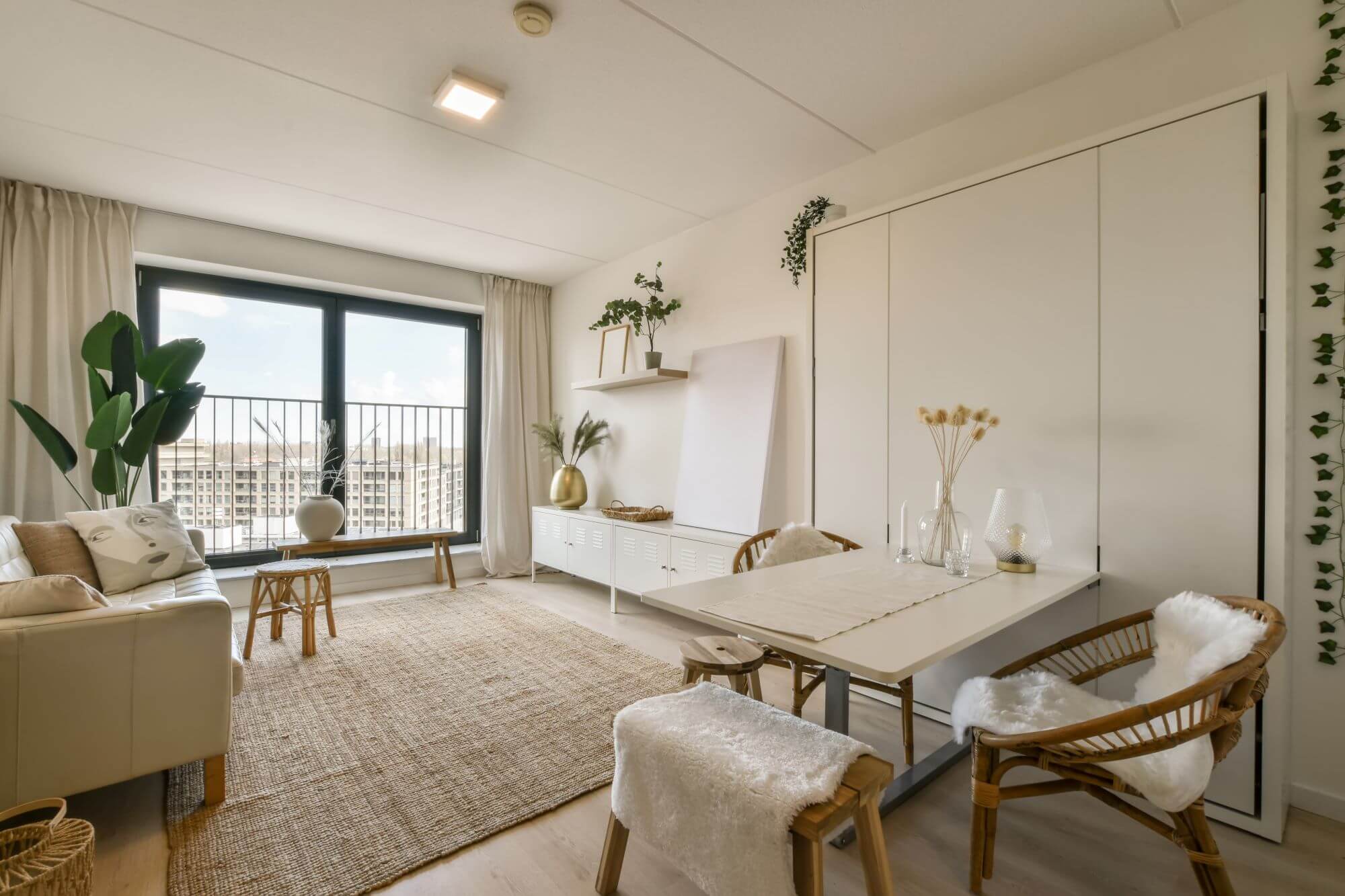 a-living-room-and-dining-room-with-a-large-window-2023-11-27-05-34-52-utc.jpg